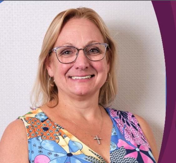 Image of Tracey McGee-Moreira, school leader of Virignia Connections Academy wearing a pink, blue, and yellow floral dress. 